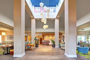 a lobby of a hospital with columns and chairs at Hilton Garden Inn Toronto-Oakville in Oakville