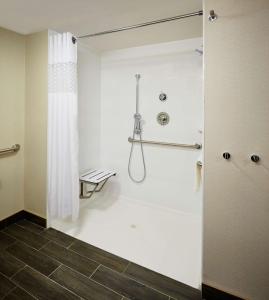 a bathroom with a shower with a shower curtain at Hampton Inn by Hilton Timmins in Timmins