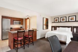 a hotel room with a bed and a kitchen at Embassy Suites by Hilton - Montreal in Montréal +31 photos