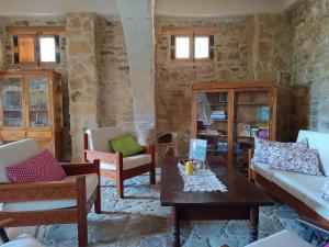 a living room with two chairs and a table at The House of Pericles in Silikou