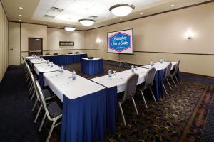 a conference room with tables and chairs and a screen at Hampton Inn & Suites Montreal-Dorval in Dorval