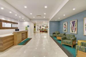 a lobby of a hospital with chairs and a counter at Home2 Suites By Hilton Montreal Dorval in Dorval