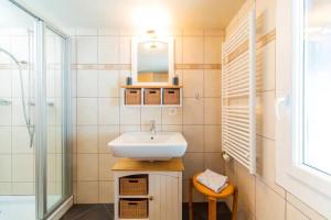 a bathroom with a sink and a mirror at First : ski-out for 4 in the central Chalet Diana in Bettmeralp