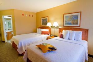 a hotel room with two beds with a tray on them at Hampton Inn - Vancouver Airport/Richmond in Richmond