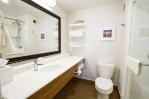 a bathroom with a sink and a toilet and a mirror at Hampton Inn - Vancouver Airport/Richmond in Richmond