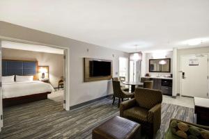 a hotel room with a bed and a living room at Hampton Inn & Suites Yuma in Yuma