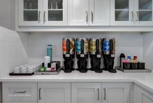 a kitchen counter with a row of water bottles at Homewood Suites by Hilton London Ontario in London