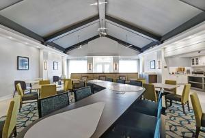 a dining room with tables and chairs at Homewood Suites by Hilton London Ontario in London