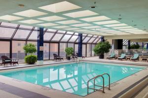 a swimming pool in a building with a ceiling at Doubletree by Hilton London in London