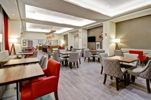 a dining room with tables and chairs and tablesktop at Hampton Inn & Suites - Medicine Hat in Medicine Hat
