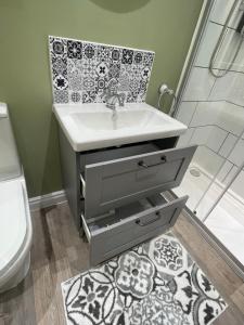 a bathroom with a sink and a shower at The Cotswold Nook in Dursley