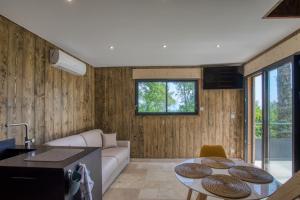 a living room with a couch and a table at Le domaine du Pech Eternel in Sarlat-la-Canéda