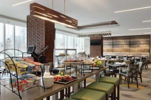 a cafeteria with a buffet of food on a table at Hilton Garden Inn Calgary Downtown in Calgary