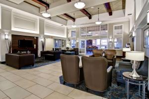 a lobby of a hotel with chairs and a fireplace at Hampton Inn & Suites by Hilton Calgary-Airport in Calgary