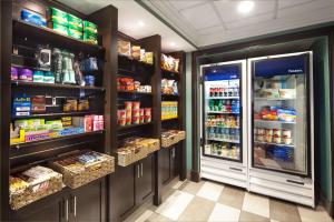 a grocery store aisle with a refrigerator and food at Hampton Inn & Suites by Hilton Toronto Airport in Mississauga