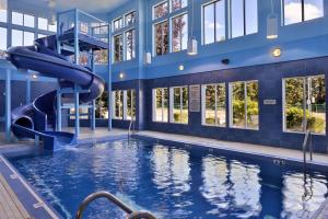 a swimming pool with a slide in a building at Hampton Inn & Suites by Hilton Calgary University NW in Calgary