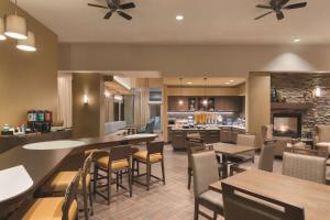 a restaurant with tables and chairs and a kitchen at Homewood Suites by Hilton Calgary Downtown in Calgary