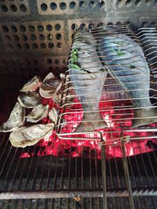 un estante de pescado cocinando en una parrilla en Casa dos Açores Cama e Café, en Florianópolis