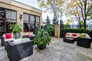 a patio with couches and plants in front of a building at Hilton Garden Inn Toronto/Markham in Thornhill