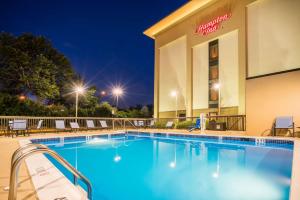 a pool in front of a hotel at night at Hampton Inn Plymouth Meeting in Plymouth Meeting