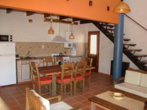 a kitchen and dining room with a table and chairs at Cabañas Mayma in Vaqueros