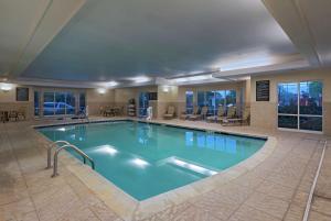 a large swimming pool in a hotel lobby at Homewood Suites by Hilton Fort Collins in Fort Collins