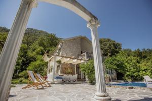 an external view of a house with a swimming pool at Villa D'amore Montenegro in Donji Morinj