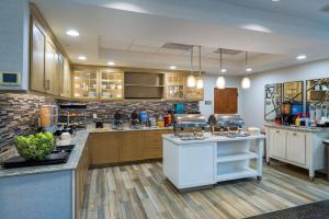 a large kitchen with wooden cabinets and a counter top at Homewood Suites Memphis Germantown in Memphis