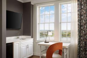 a kitchen with a desk and a window at The Terrace Hotel Lakeland, Tapestry Collection by Hilton in Lakeland