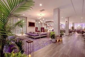 a lobby with a purple couch and some plants at Hilton Garden Inn Toronto/Brampton West, Ontario, Canada in Brampton