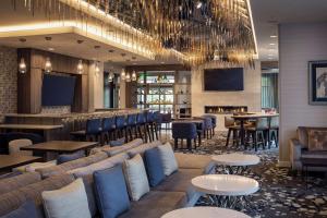 a restaurant with couches and tables and a bar at Homewood Suites by Hilton Needham Boston in Needham