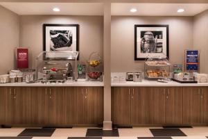 a restaurant with two counters with food on them at Hampton Inn Channel Islands Harbor in Oxnard