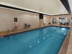 a large swimming pool with blue water in a building at Hilton Harrisburg near Hershey Park in Harrisburg