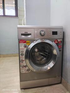 a washing machine is sitting in a room at 3 Luxury BedRoom Set OSHO Villa Jaipur Airport in Jaipur