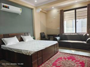 a bedroom with a large bed and a couch at 3 Luxury BedRoom Set OSHO Villa Jaipur Airport in Jaipur