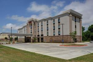a large white building with a parking lot at Hampton Inn & Suites Ardmore in Ardmore