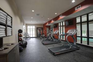 a gym with treadmills and chairs in a room at Hampton Inn & Suites Ardmore in Ardmore