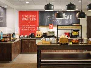 a fast food restaurant with a counter with food at Hampton Inn Pinellas Park St Petersburg, Fl in Pinellas Park