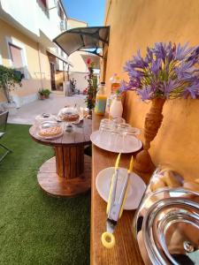 a table with plates of food and flowers on it at Hera Tropea Rooms in Tropea