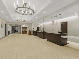 a large lobby with a reception desk and a chandelier at DoubleTree by Hilton Charlottesville in Charlottesville