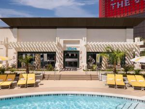 a pool at a hotel with chairs and a building at Las Vegas Hilton At Resorts World in Las Vegas