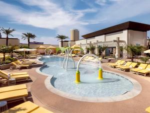 a pool with a water slide in a resort at Las Vegas Hilton At Resorts World in Las Vegas