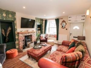 a living room with a couch and a fireplace at Goosedale Cottage in Scarborough