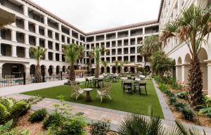 un patio con mesas y sillas en un edificio en Estancia del Norte San Antonio, A Tapestry Hotel by Hilton en San Antonio