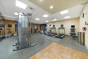 a gym with treadmills and machines in a room at Hilton Garden Inn Lawton-Fort Sill in Lawton