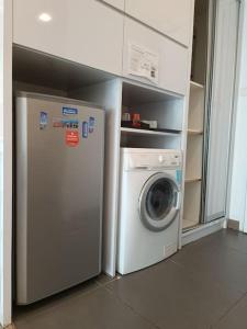 a washing machine and a washer in a kitchen at RM219 Bukit Bintang Balcony Studio Infinty Pool in Kuala Lumpur