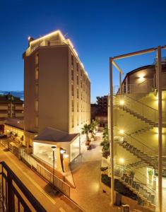 a view of a building at night with lights at Residence Continental Resort in Gabicce Mare
