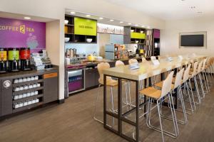 a cafeteria with a long table and chairs in a store at Home2 Suites by Hilton Charlotte Airport in Charlotte