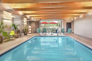 a swimming pool in a hotel with a wooden ceiling at Home2 Suites By Hilton Harrisburg in Harrisburg