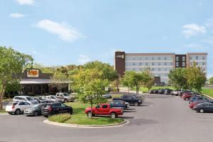 a parking lot with cars parked in front of a building at Home2 Suites By Hilton Harrisburg in Harrisburg